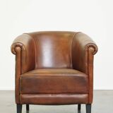 Neat, elegantly finished, cozy sheepskin club armchair with a fixed seat cushion