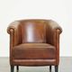 Neat, elegantly finished, cozy sheepskin club armchair with a fixed seat cushion