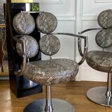 Pair of italian swivel armchairs in chrome-plated metal and piton imitation fabrics