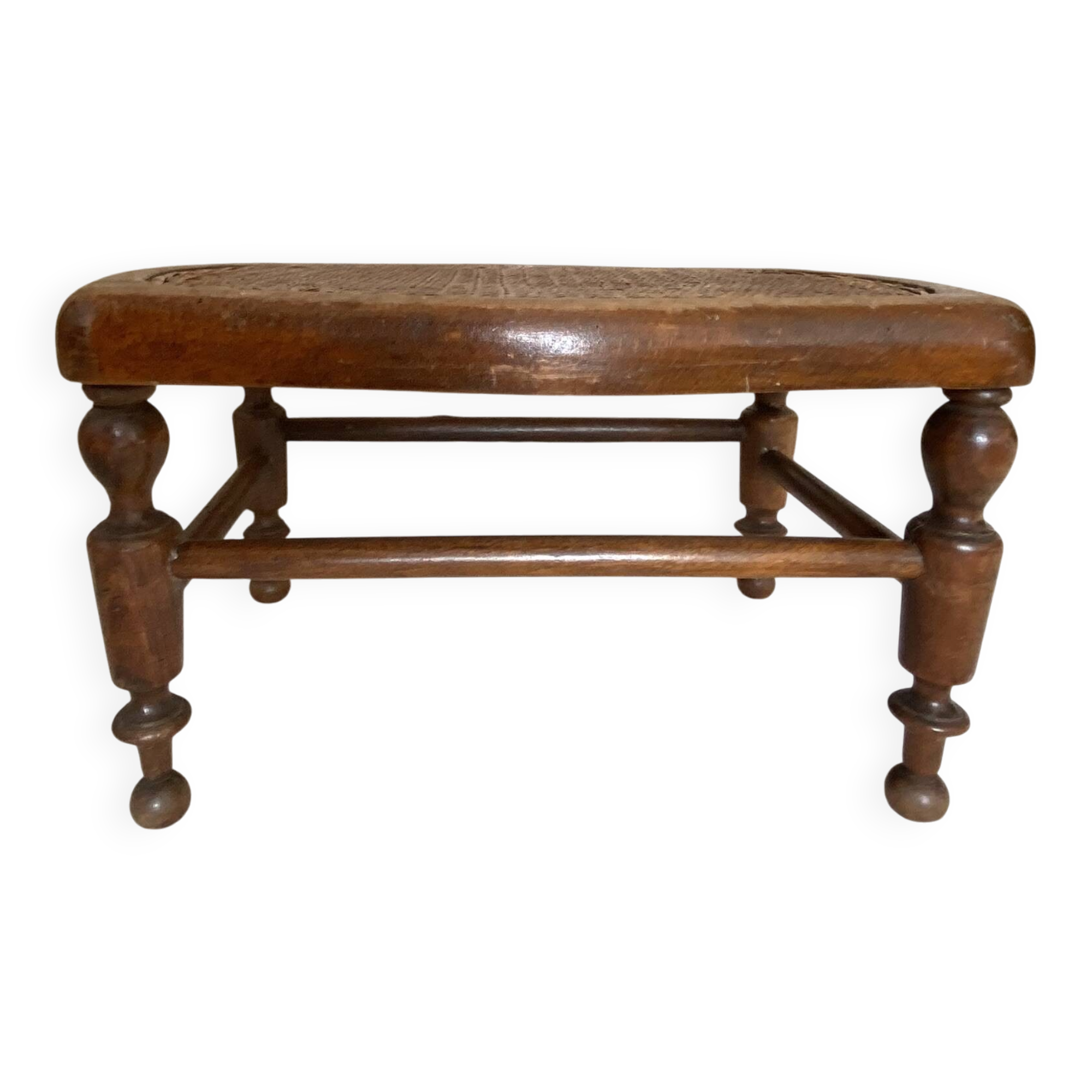 Low wooden stool with caning, footrest.