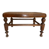 Low wooden stool with caning, footrest.