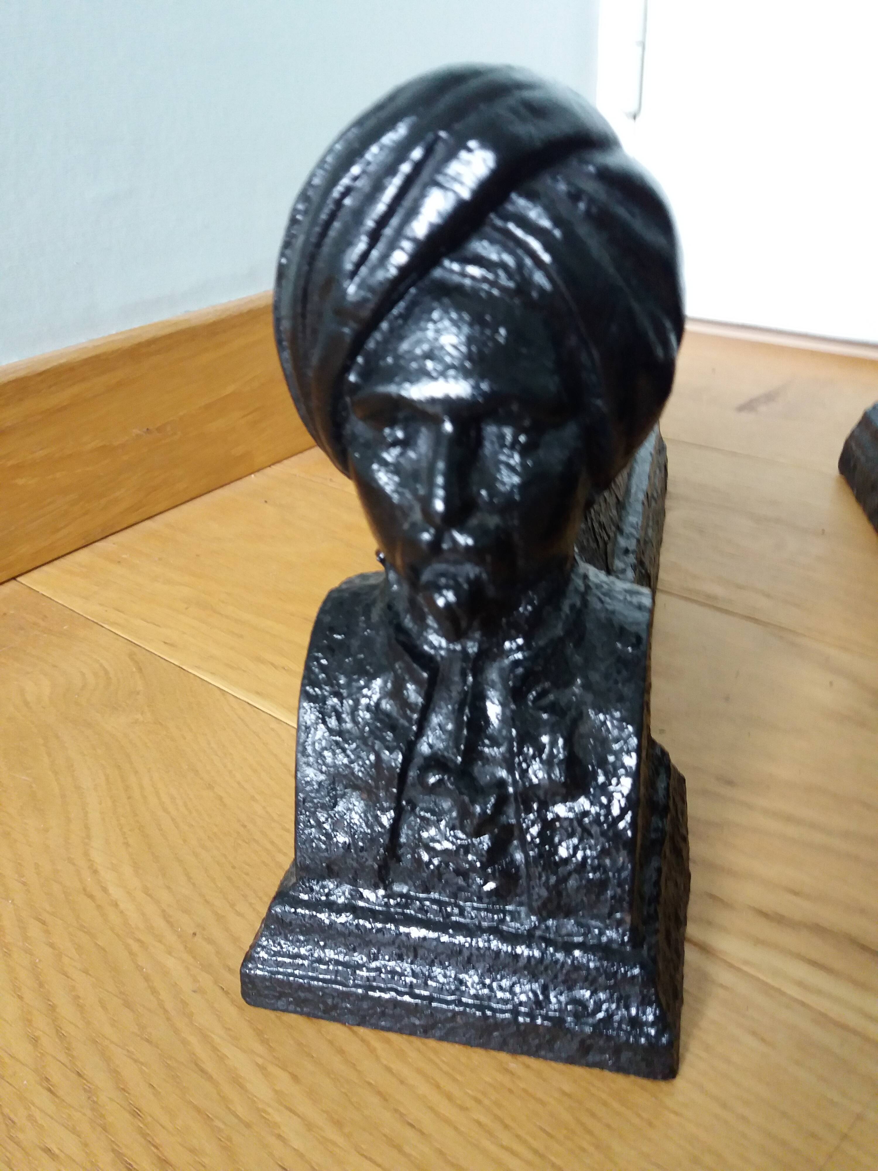 Cast iron andirons with character heads