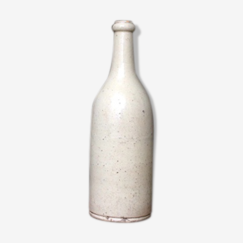 Old bottle in sandstone