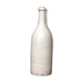 Old bottle in sandstone