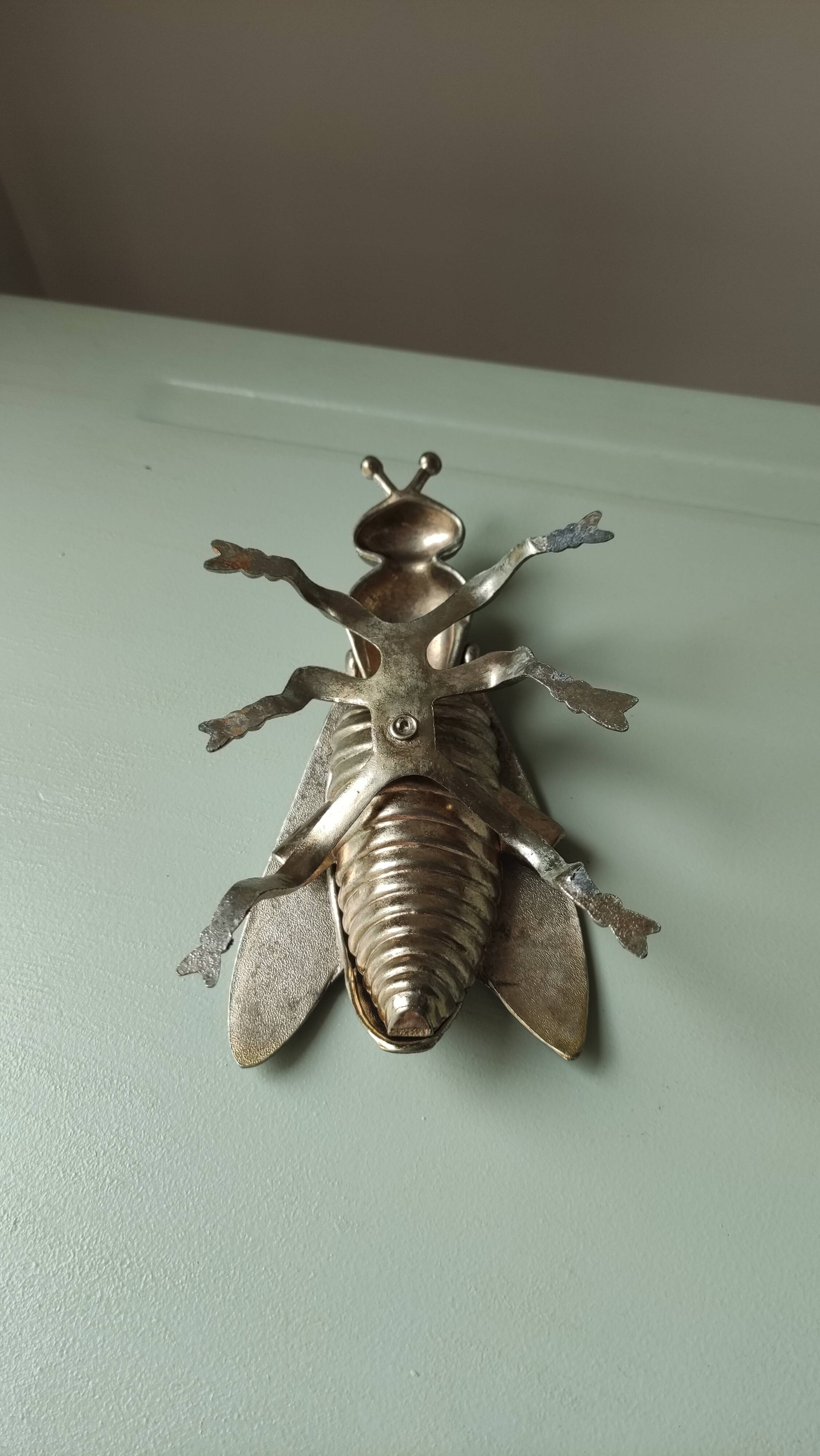 Vintage metal fly, old ashtray to divert