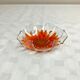 Glass cup with orange sunflower