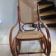 Rocking-chair in turned wood and cannage