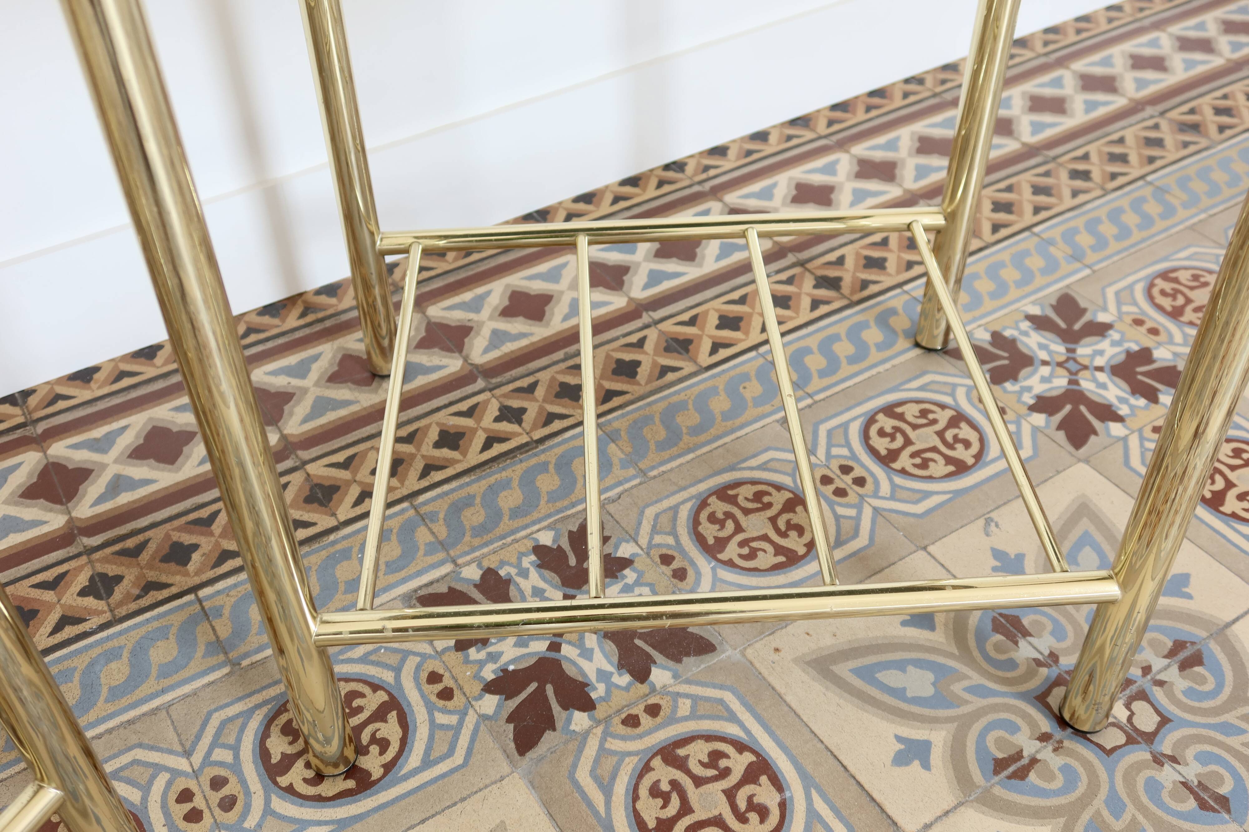 Pair of bedside tables with gold metal and mirrored glass top.