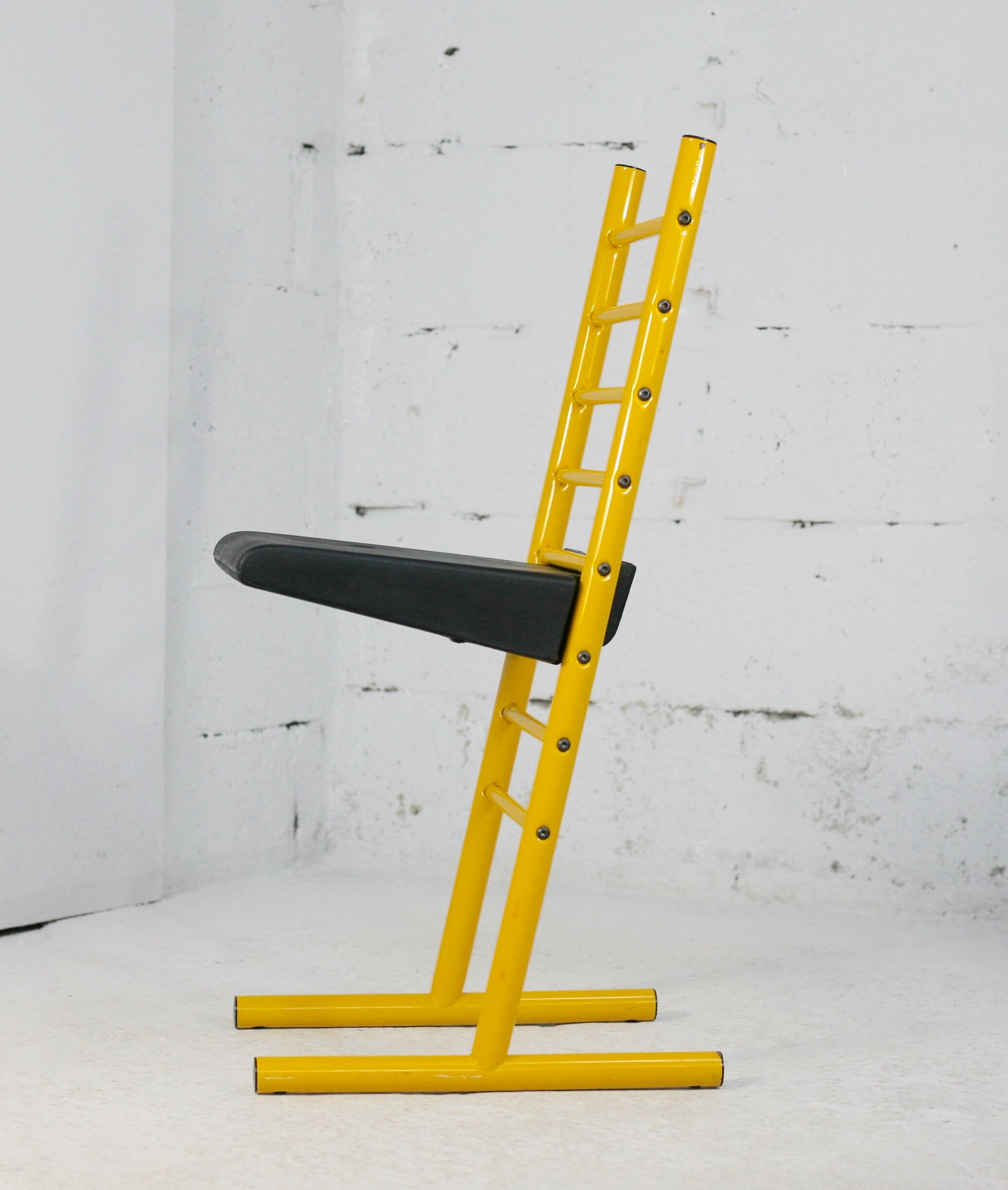 Adjustable seat chair. Circa 1980. Italy. Yellow lacquered steel.