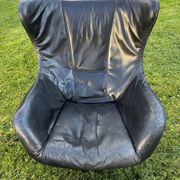 Egg chair style armchair and its ottoman.