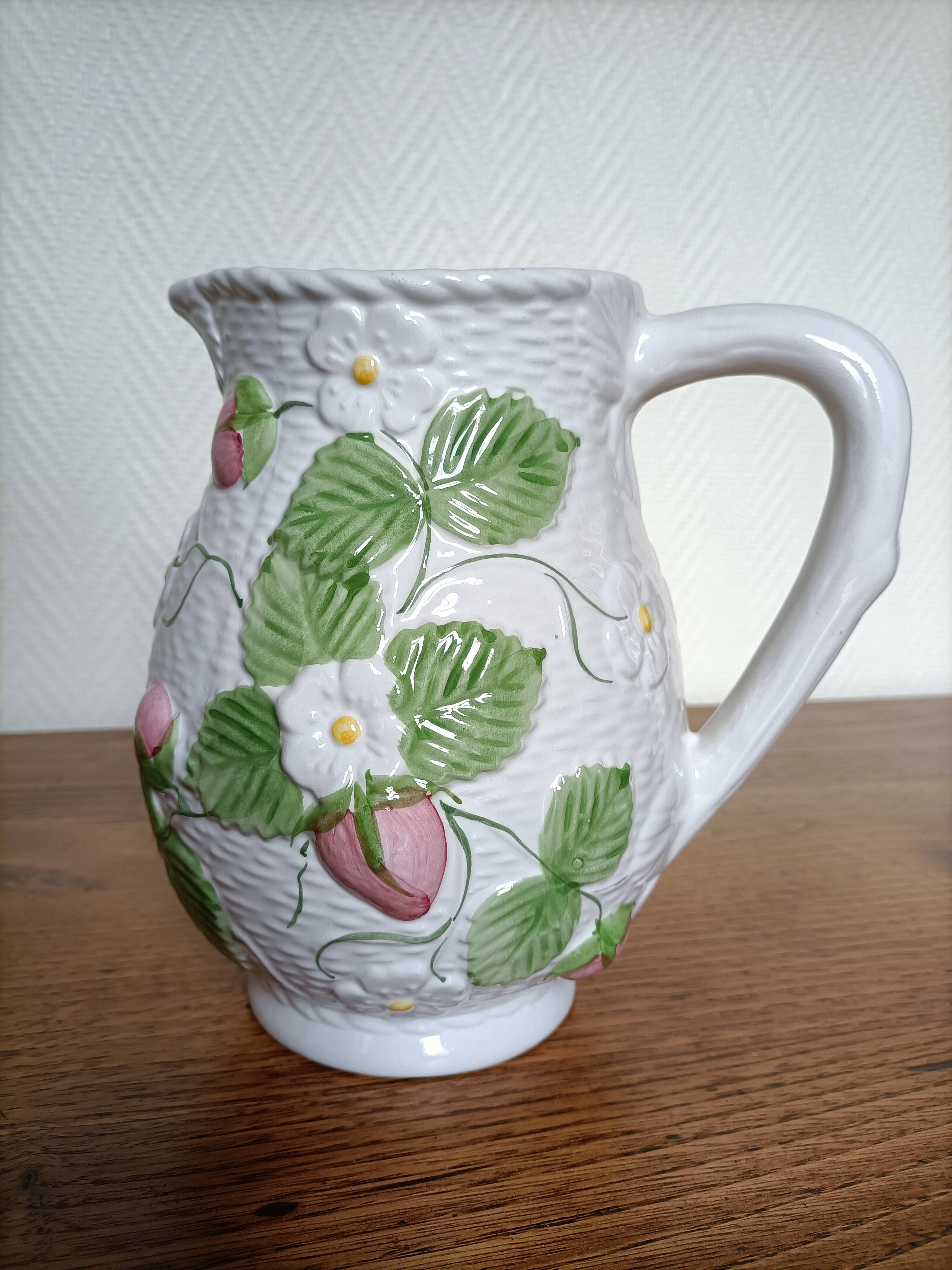 Barbotine pitcher with pastel flower decoration