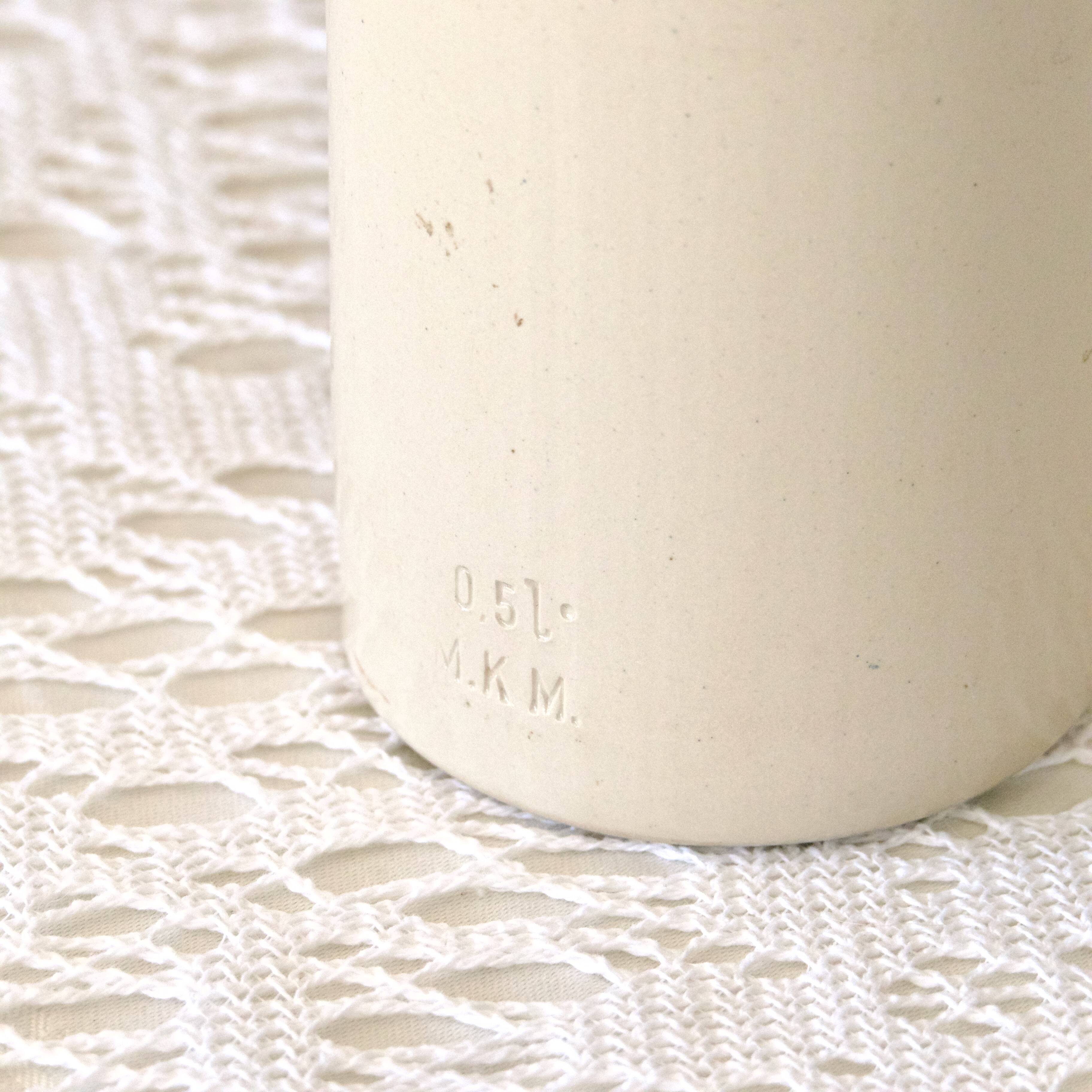 Antique enamelled stoneware beer bottle signed MKM