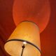 Vintage 1960s floor lamp with black tripod base and round varnished wooden shelf
