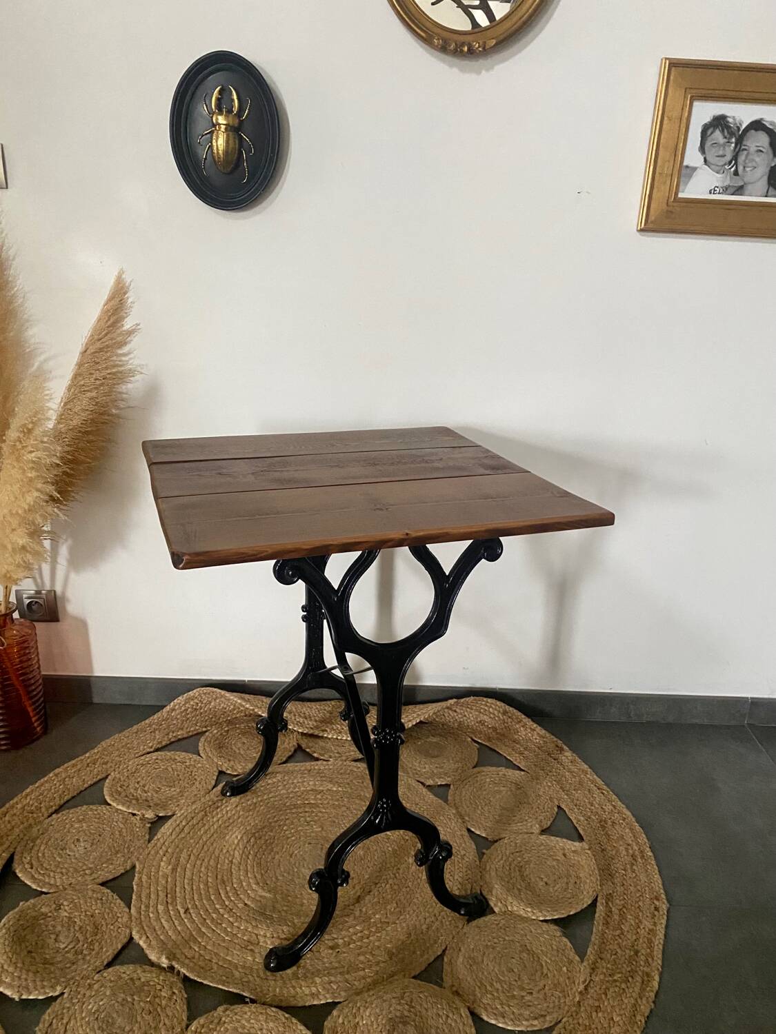 Bistro table with iron legs and raw wood top.