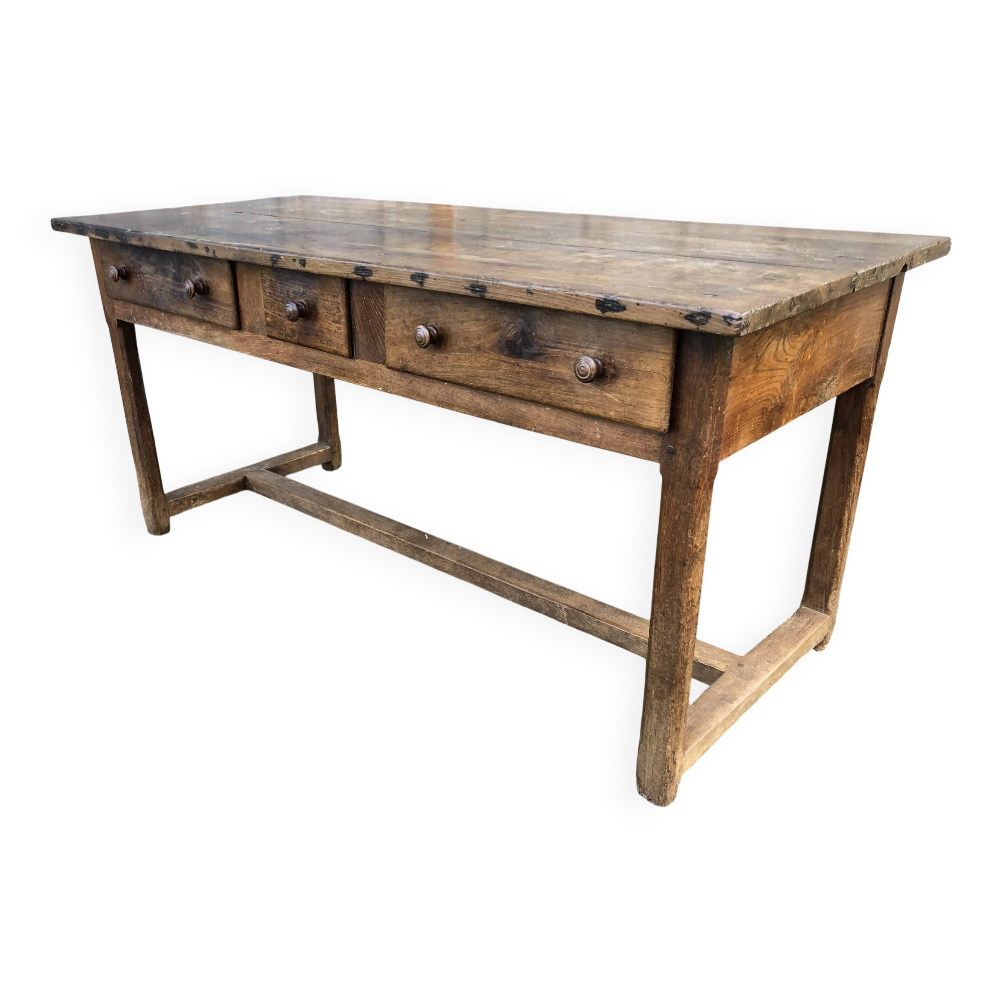 Old chestnut table with 3 front drawers and a cat bar.
