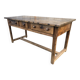 Old chestnut table with 3 front drawers and a cat bar.