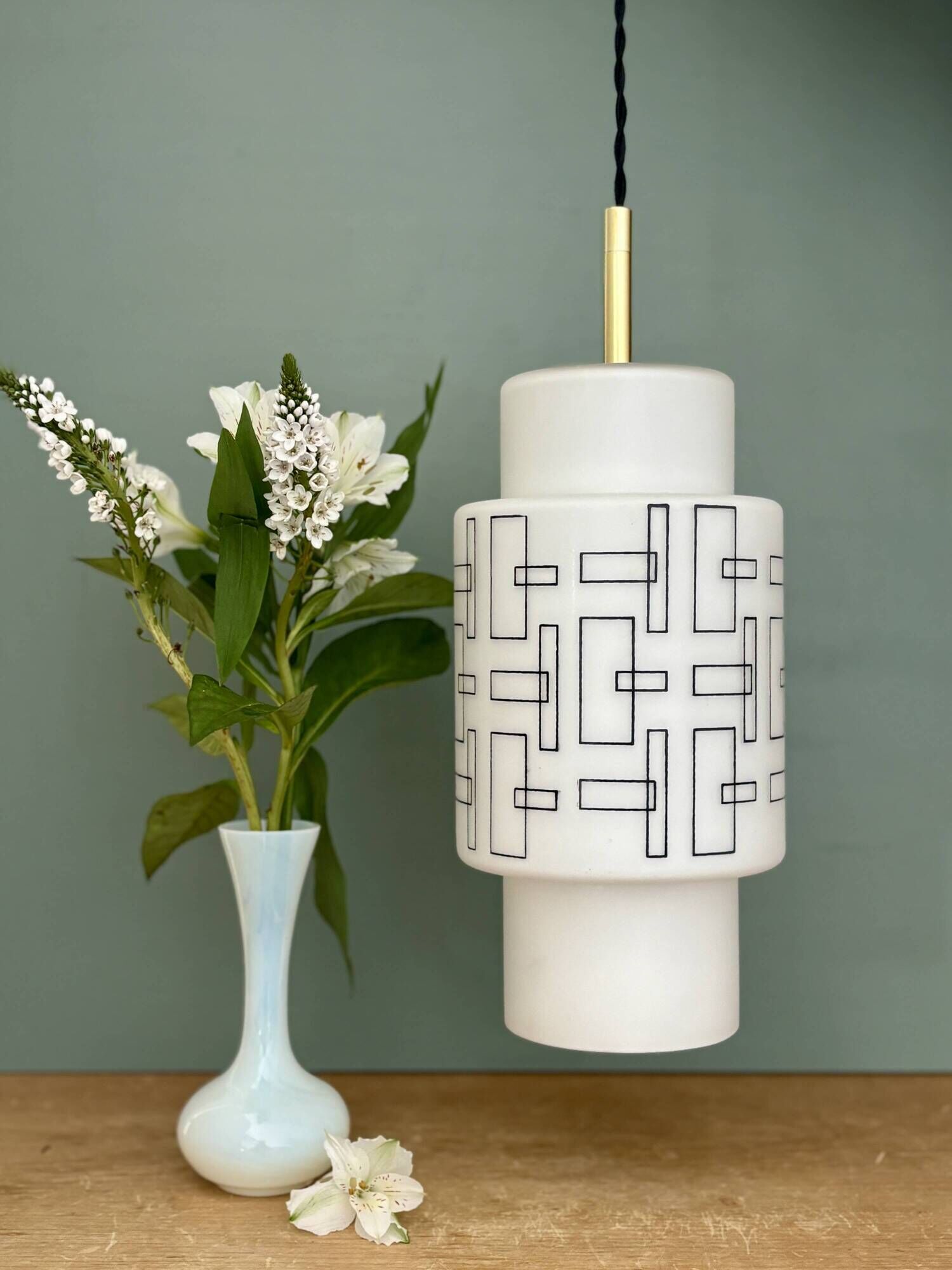 Vintage suspension globe in white opaline with black drawings.