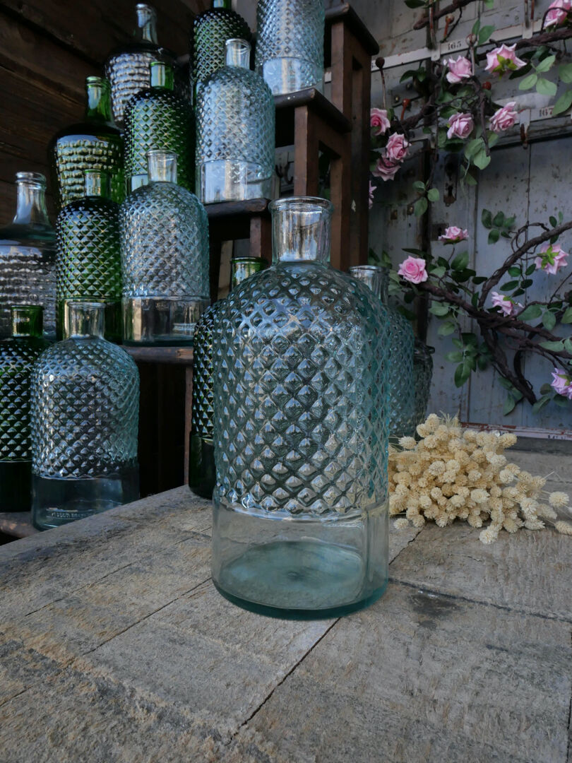 Recycled glass bottle with green water pegs