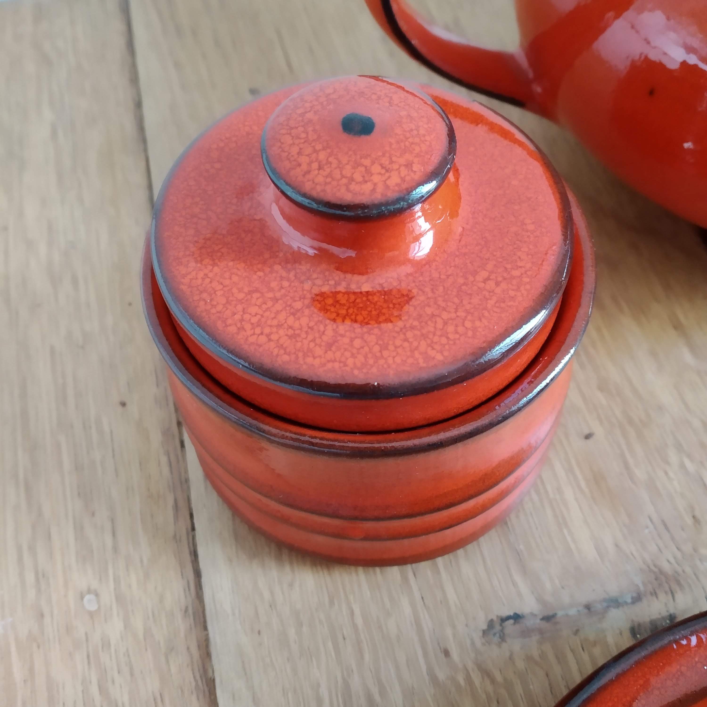 Red ceramic tea service