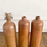 Trio of old sandstone bottles