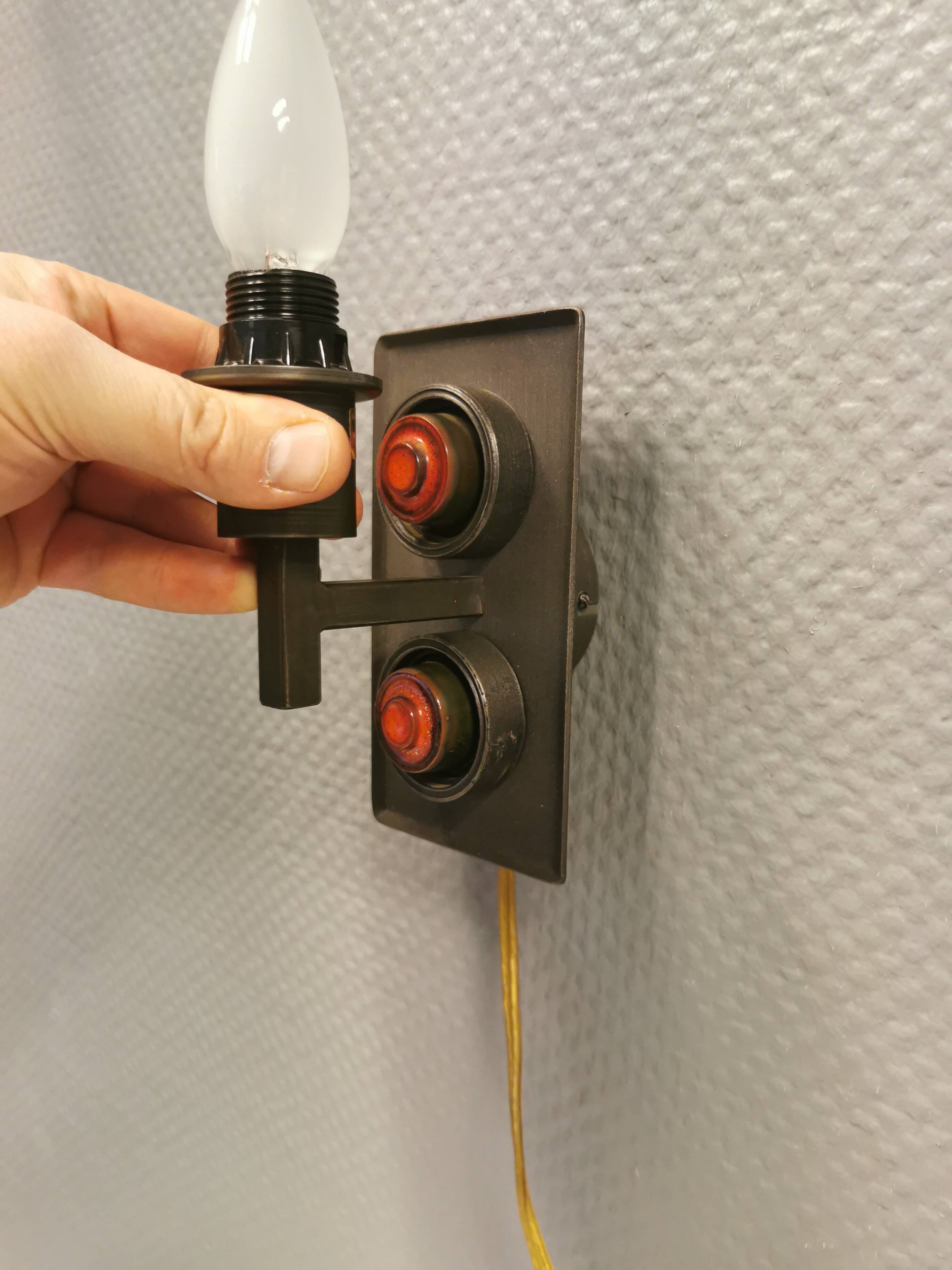 A set of Vitrika Denmark, cast iron wall lights with red details.