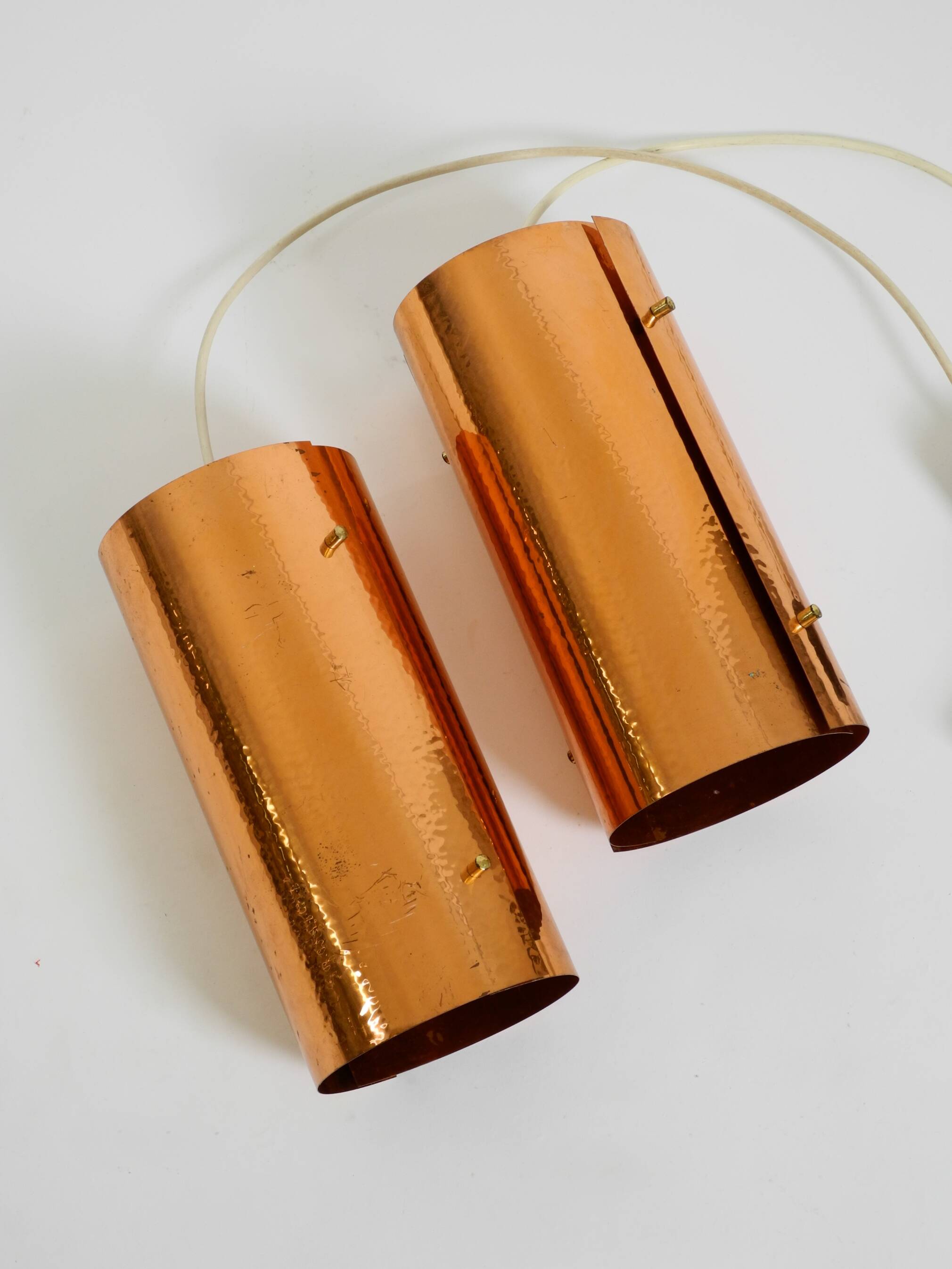 Two 50s tube pendant lamps consisting of two screwed-together copper bowls