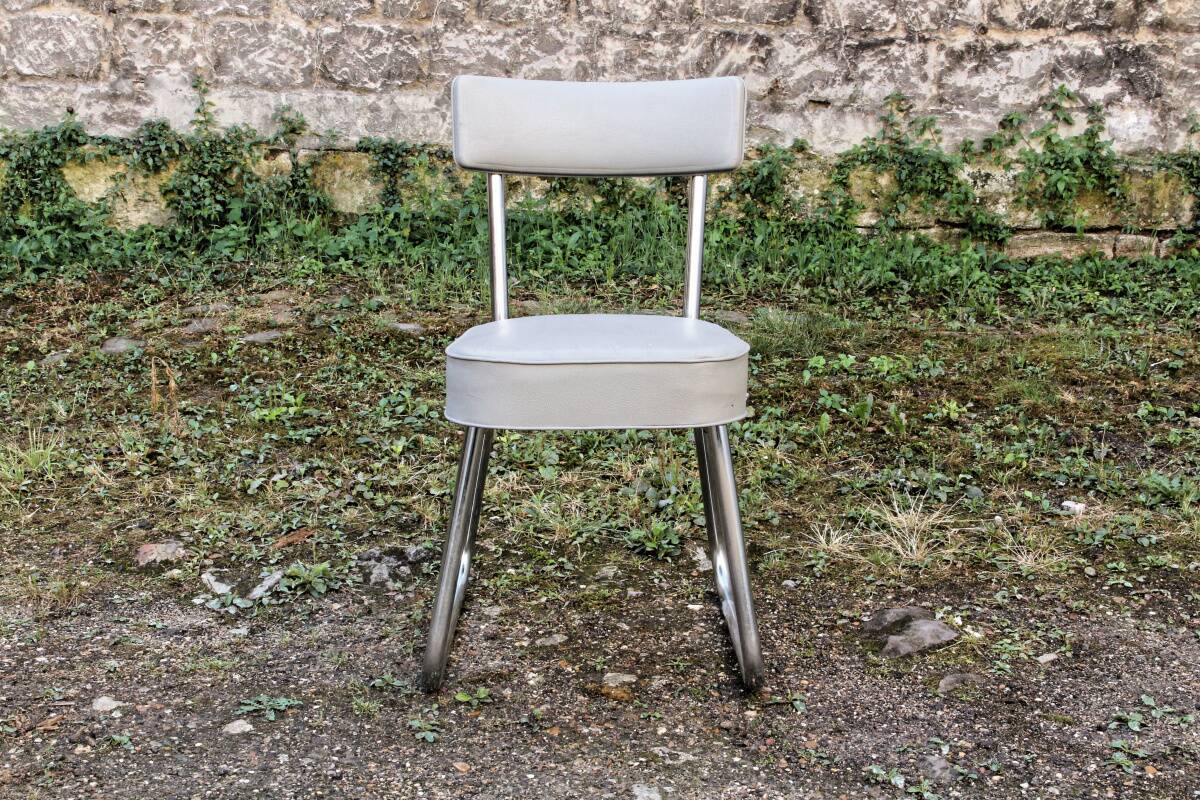 Set of 2 chairs and 1 armchair from the 70s in chrome metal and faux leather.