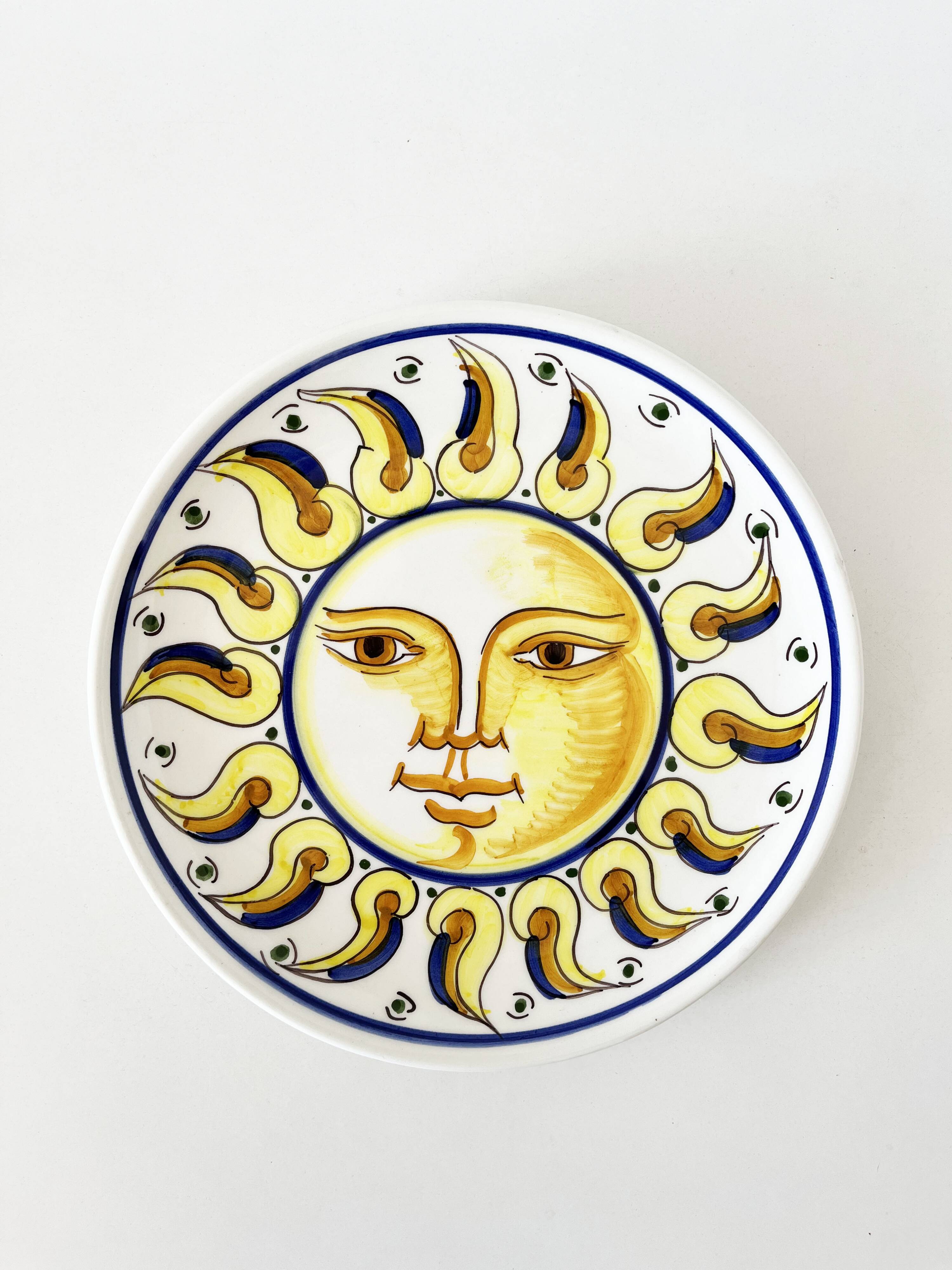 Decorative ceramic plate with sun face