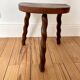 Vintage wooden half-moon tripod stool with twisted legs