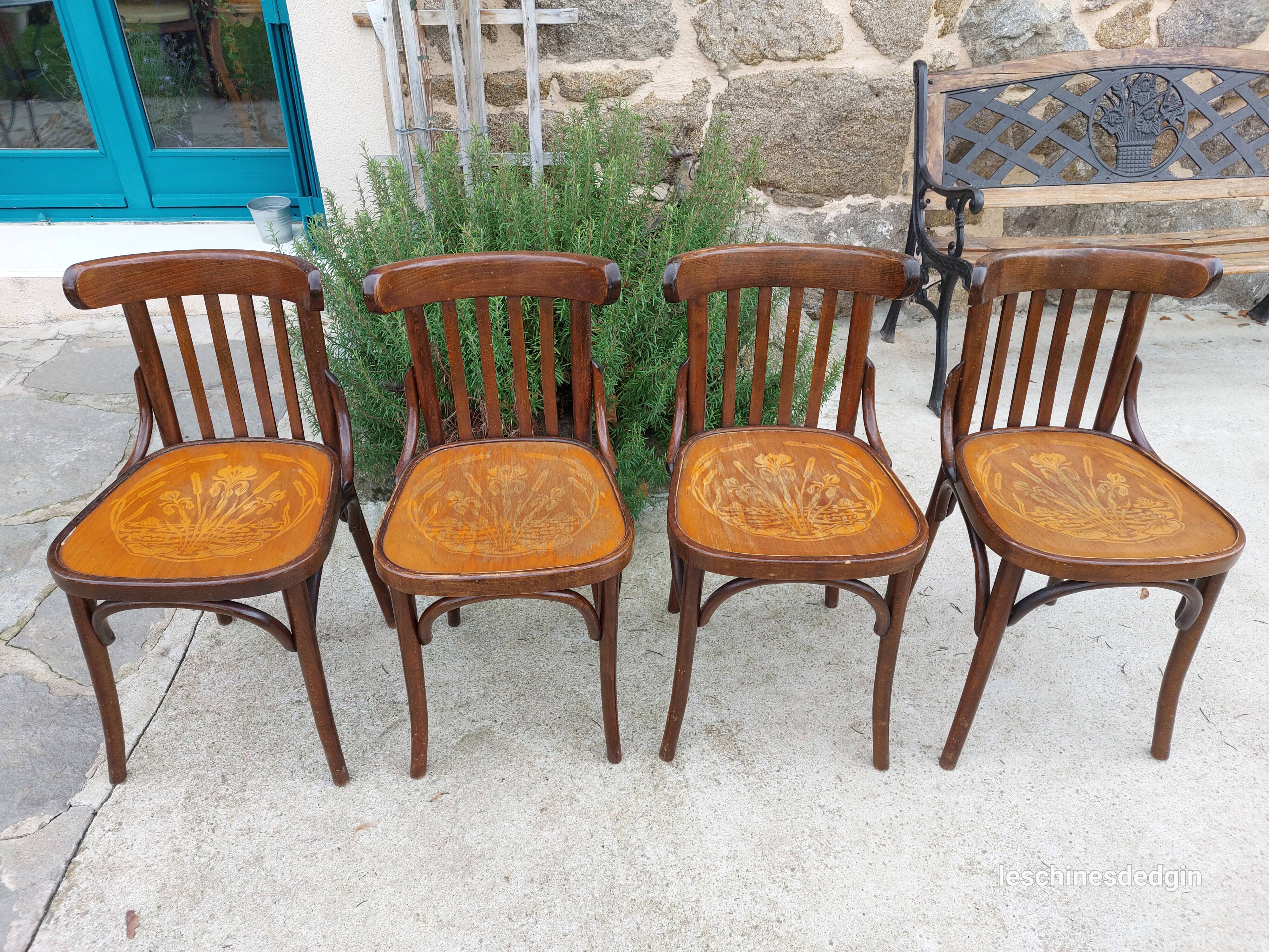 4 bentwood bistro chairs with a pattern on the seat