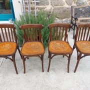 4 bentwood bistro chairs with a pattern on the seat