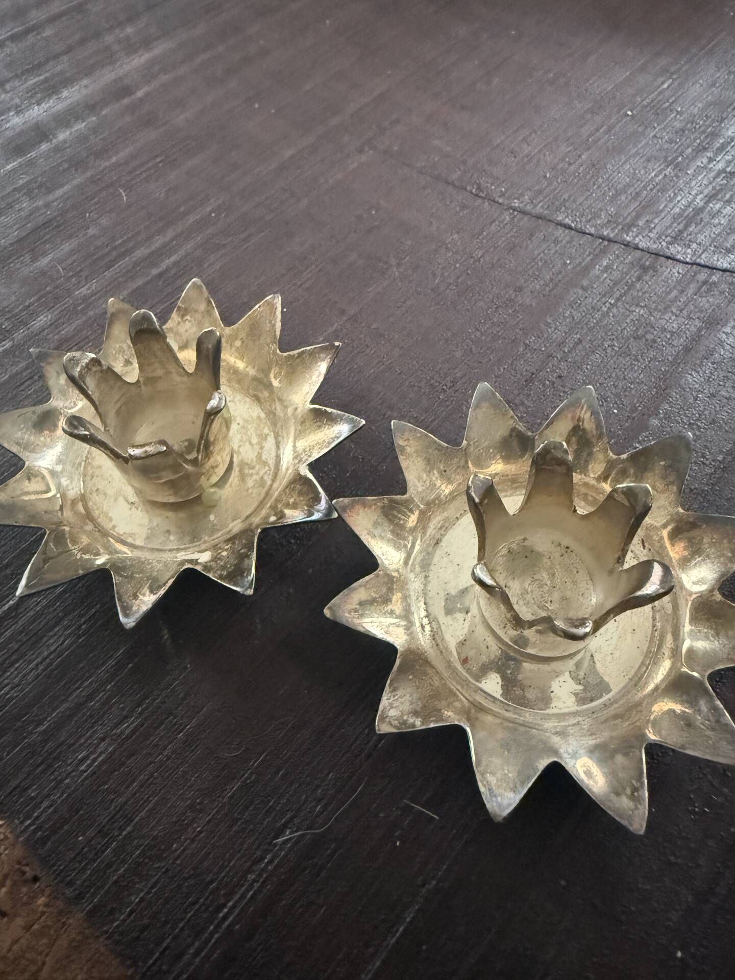 Pair of brass candle holders in the shape of a lotus flower.