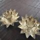 Pair of brass candle holders in the shape of a lotus flower.