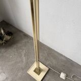 Floor lamp with articulated arm in brass-plated metal