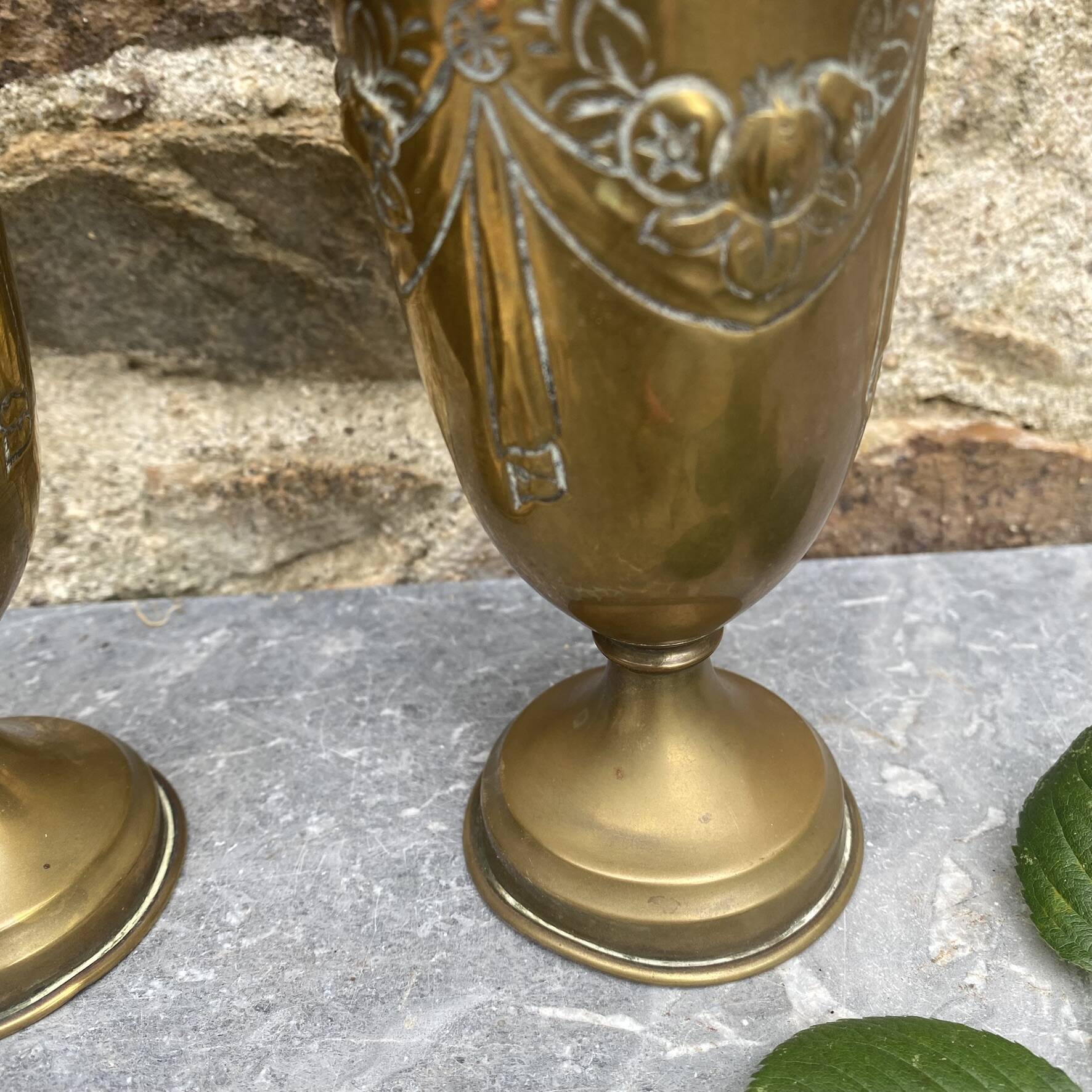 Pair of embossed brass bud vases stamped 17 cm