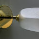 Translucent antique glass wall lamp mounted on a brass metal stand