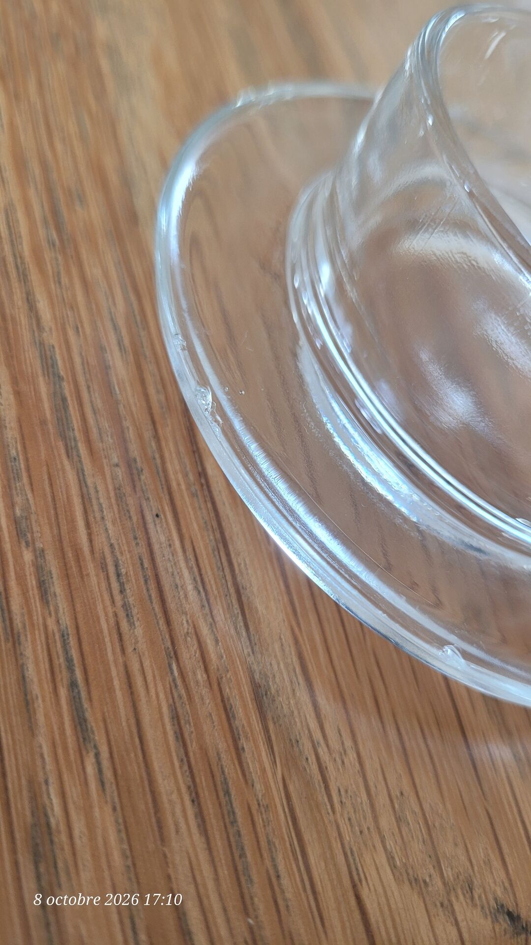 2 transparent glass butter dishes accompanied by their matching cloches.