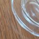 2 transparent glass butter dishes accompanied by their matching cloches.