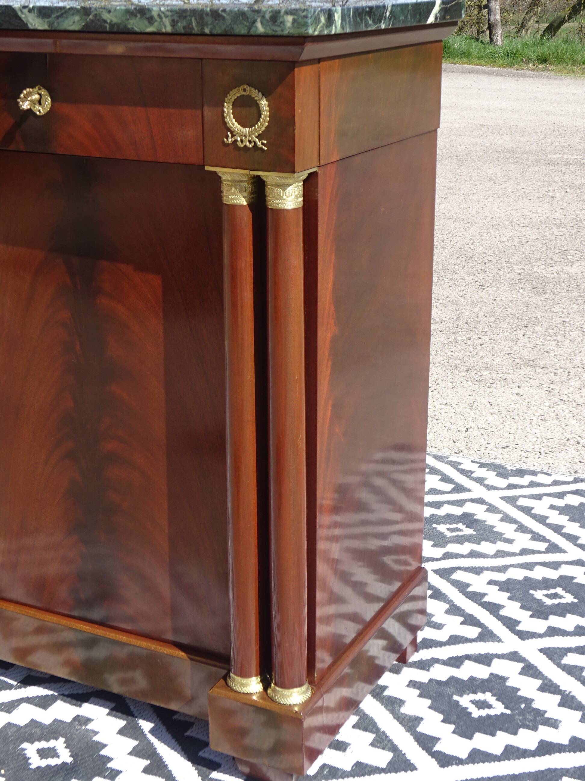 Flamed mahogany enfilade with sea green marble in Empire style.