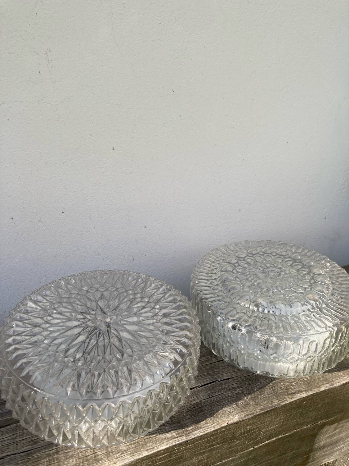 Pair of transparent round glass wall lights