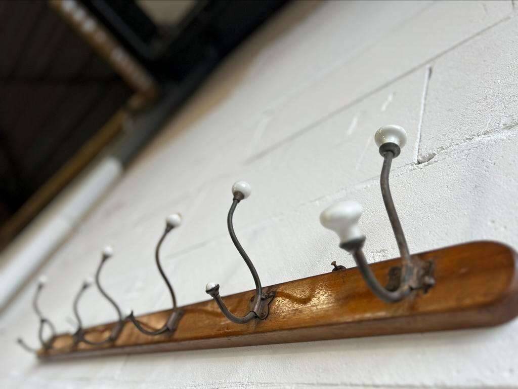 Vintage industrial wooden coat rack with porcelain hooks