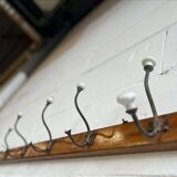 Vintage industrial wooden coat rack with porcelain hooks