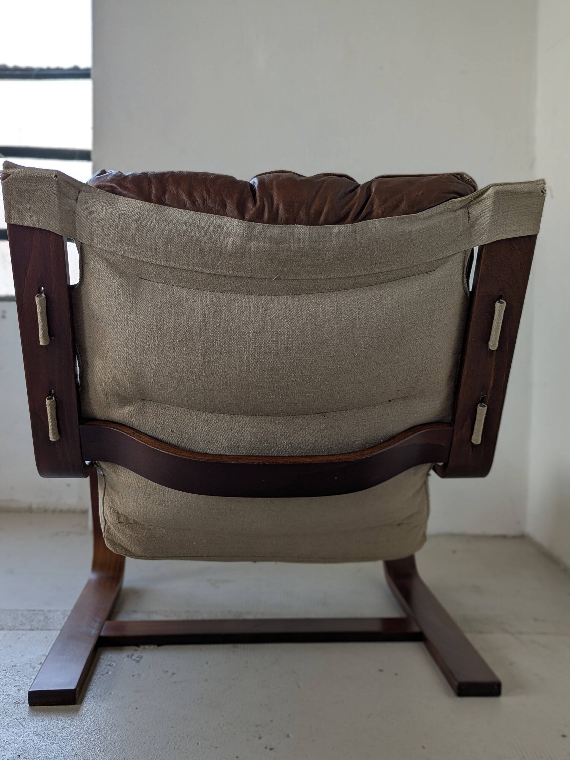 Leather and wood armchair, brutalist style.