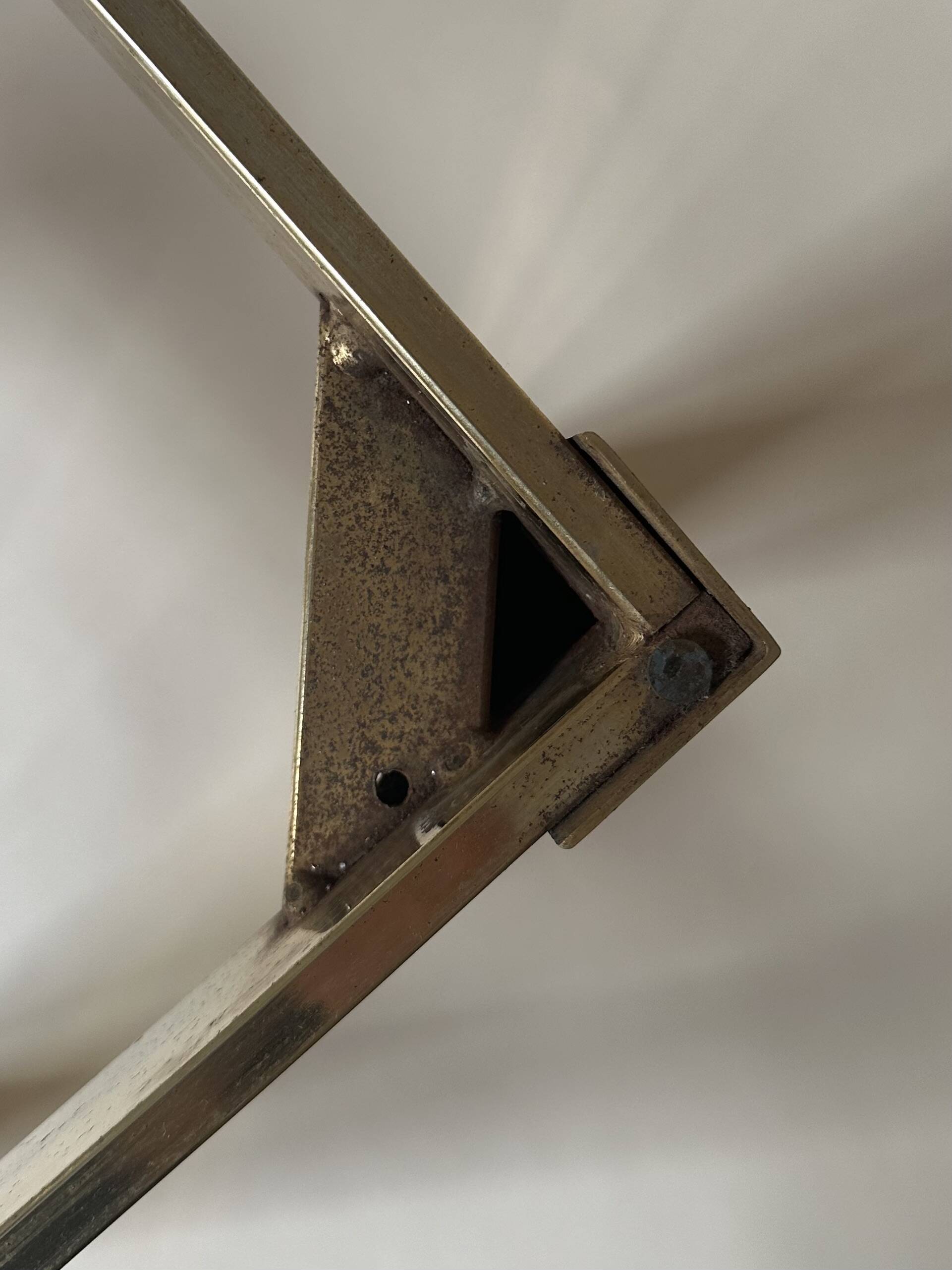 Set of three nesting side tables in brass and smoked mirror.