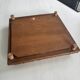 Vintage wooden and antique earthenware trivet, brown tile design