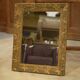 19th-century mirror in wood and stucco with floral decoration.
