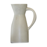 White ceramic pitcher with yellow background
