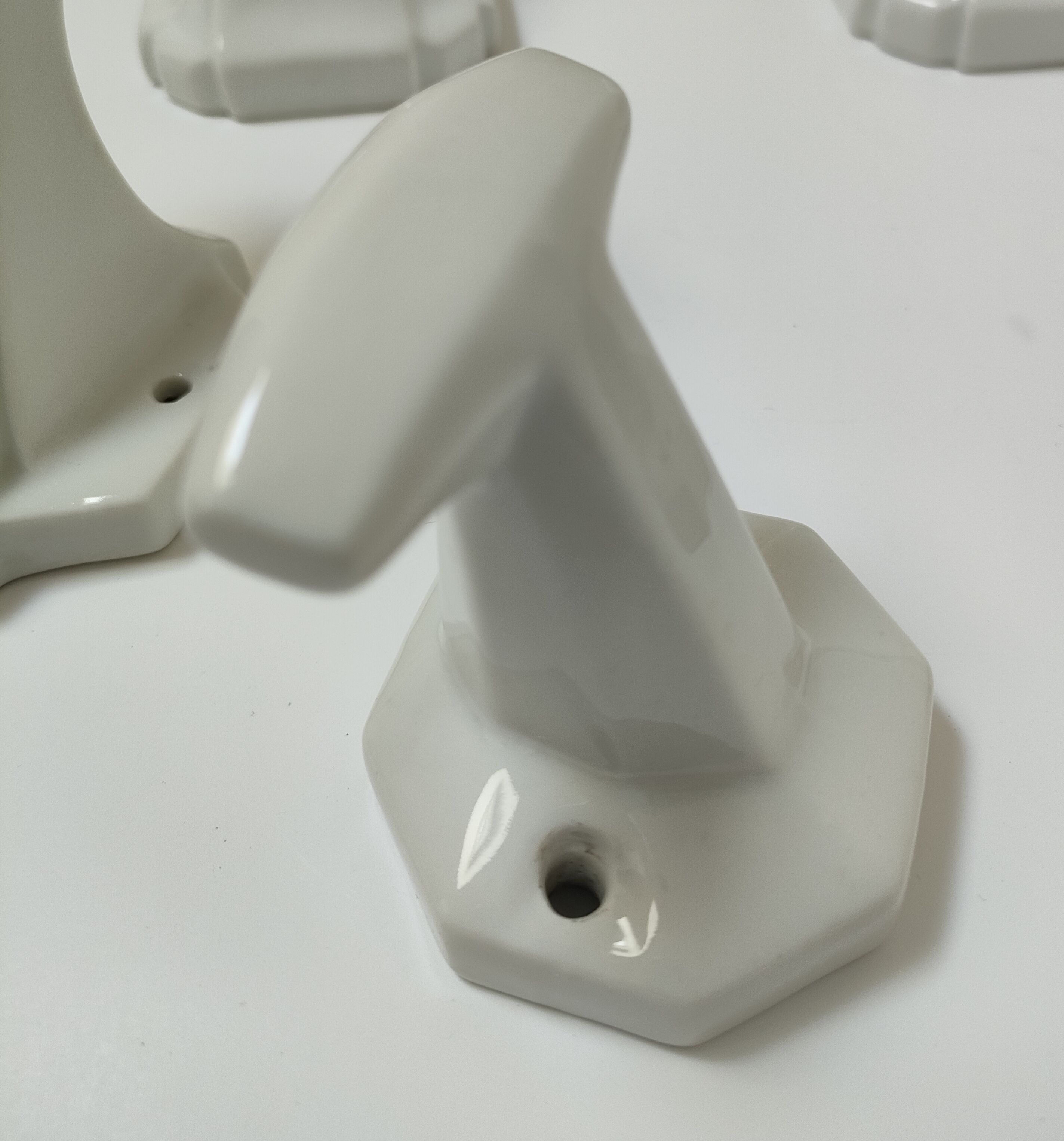 Five art deco white porcelain hooks