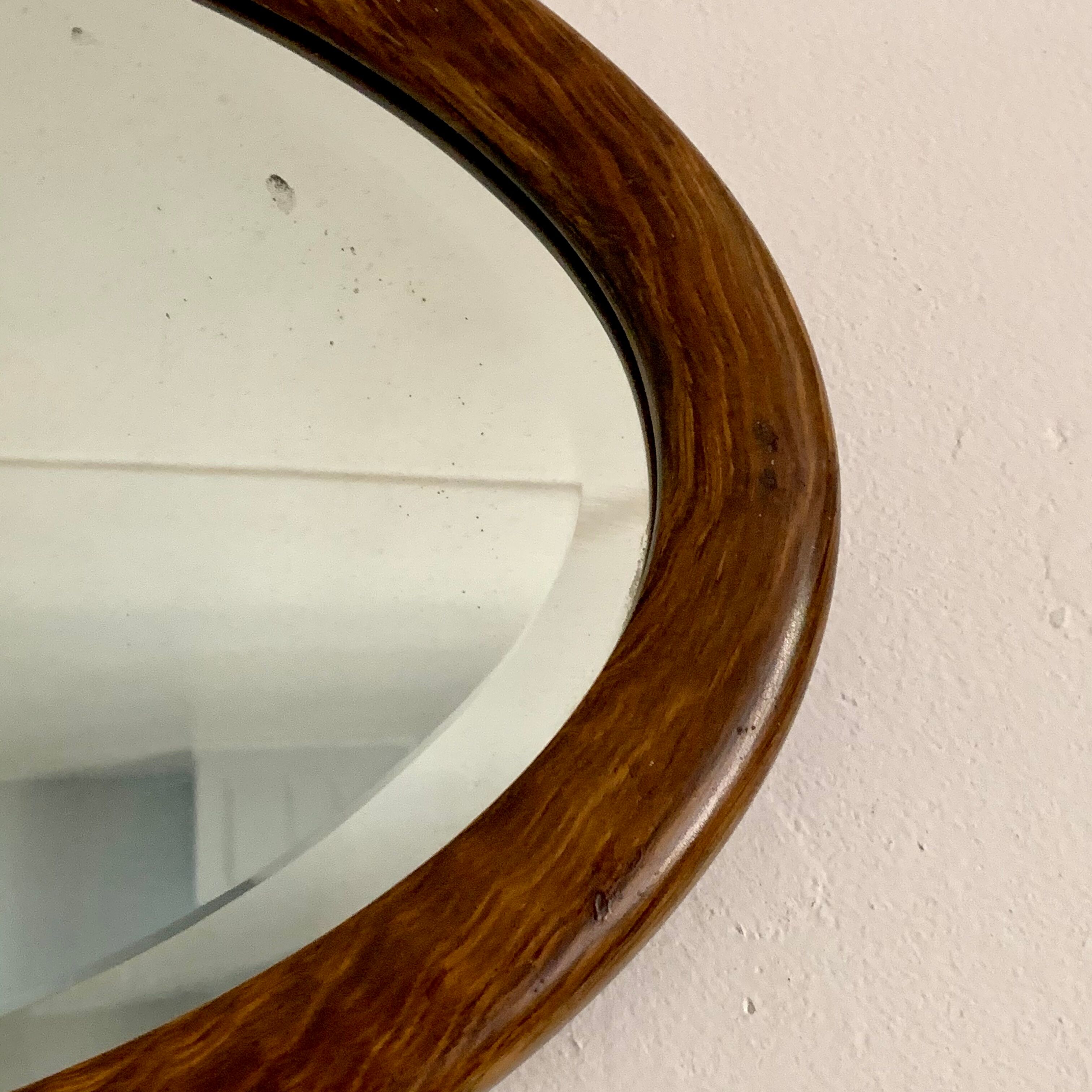 Oval wooden and stucco wall mirror