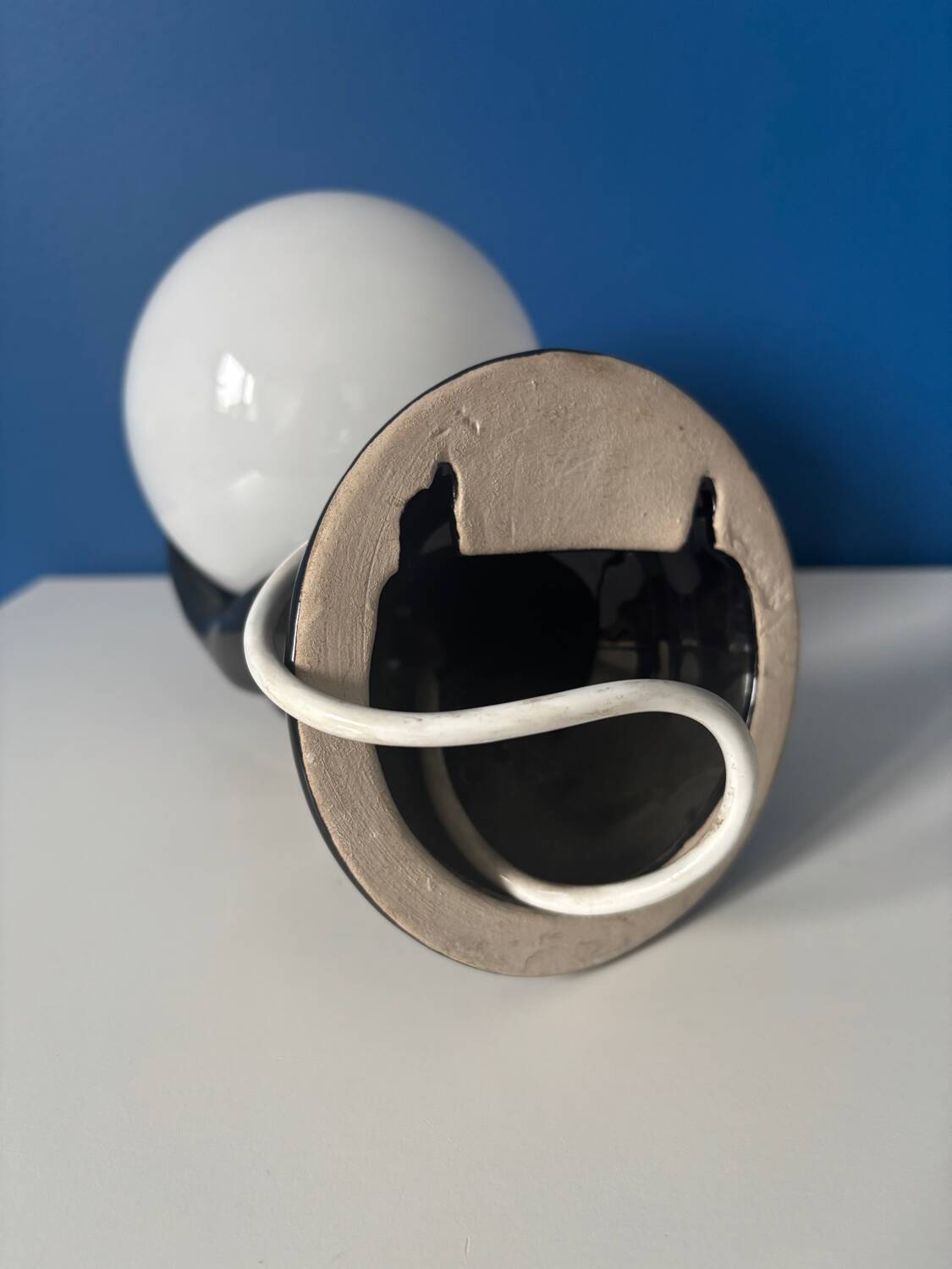 Vintage wall sconce with black hand and white opaline glass globe, 1970s L
